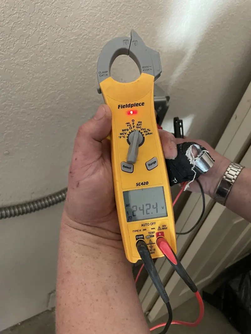 Voltage testing with clamp meter during Recessed Lighting Installation in Alfred